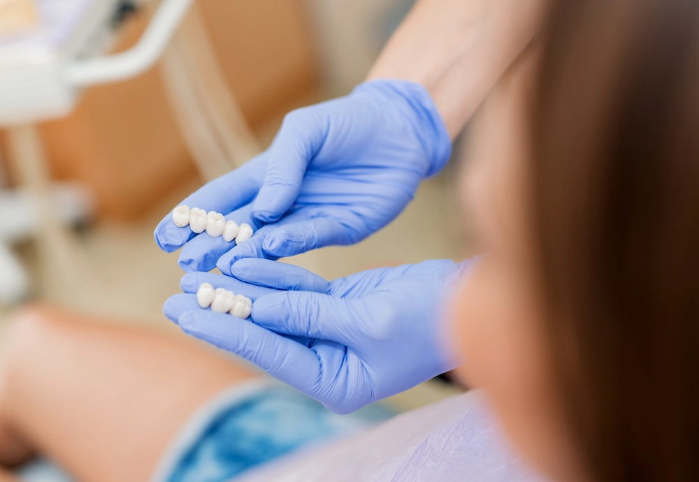 dentists hands holding implants