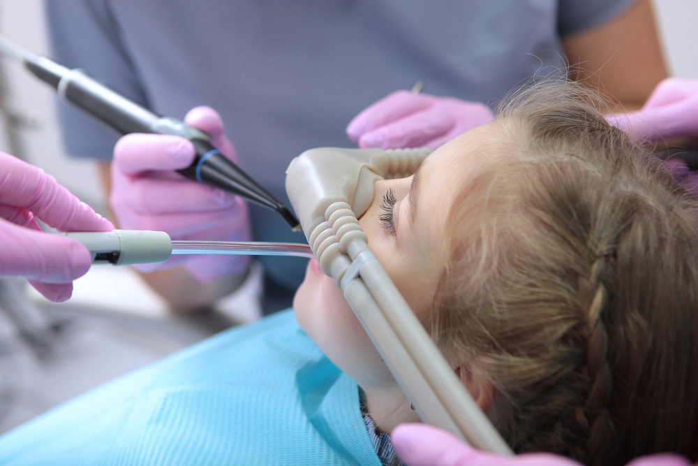 child sedated in dentist chair - sedation